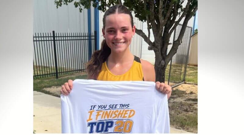 Ripley senior Jenna-Lynne Massengill holds a cross-country top-20 finisher shirt.