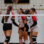 Walnut takes 12-match winning streak into North State rematch at East Union Volleyball players in red and white Wildcats uniforms gather beside the net.